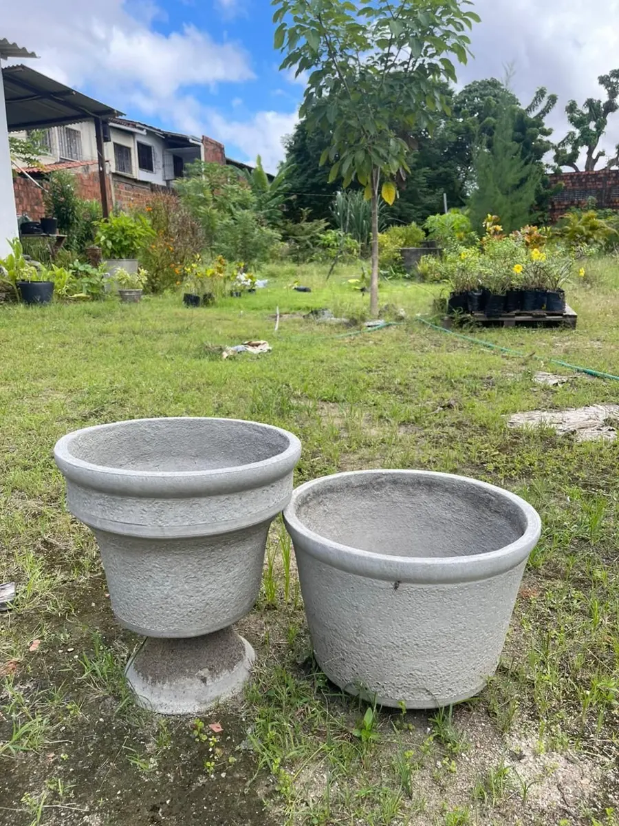 Dois vasos de concreto de formatos diferentes, feitos com o kit